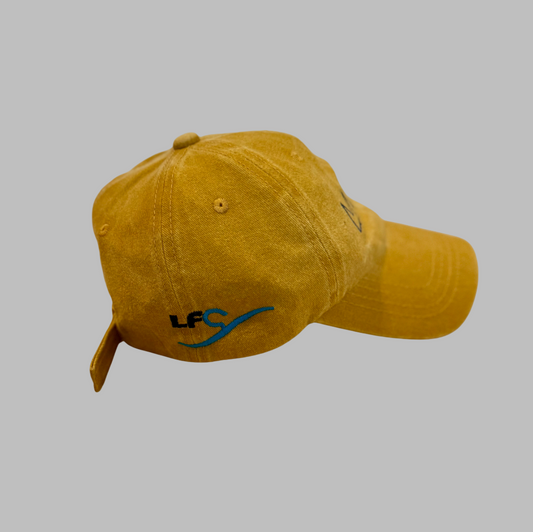 Yellow cap with a logo on a gray background