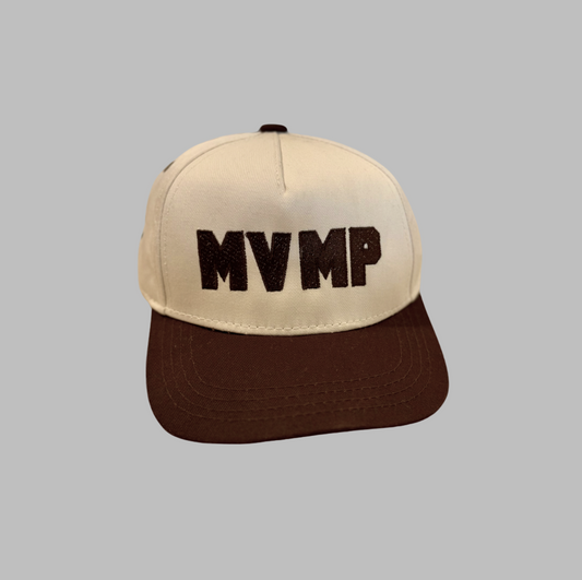 Beige and brown cap with 'MVMP' text on a gray background
