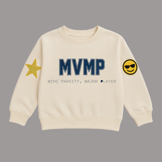 Beige sweatshirt with 'MVMP' text and star and smiley face designs on a white background